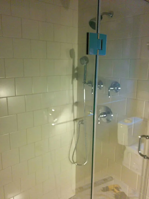 Tiled shower with glass enclosure and rain shower head