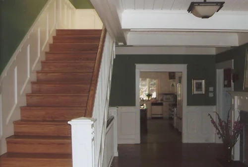 Interior renovation with a new hardwood staircase and painted trim