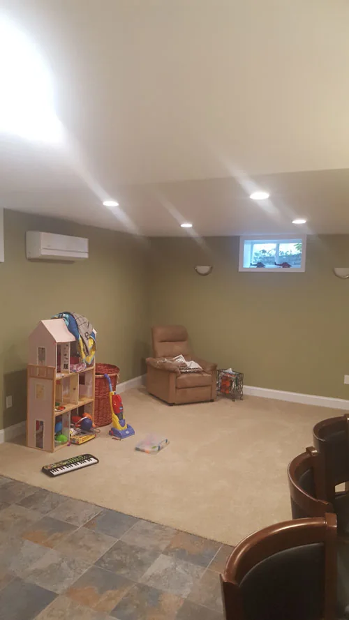 Finished basement family room with recessed lighting