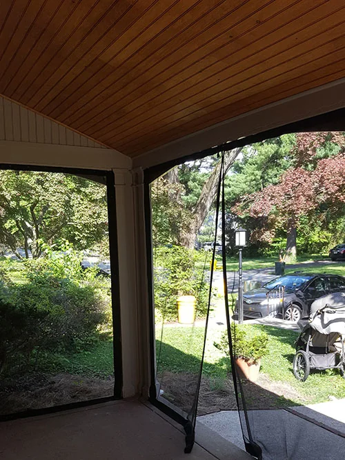 Covered porch with a wood ceiling and snap-on mosquito netting